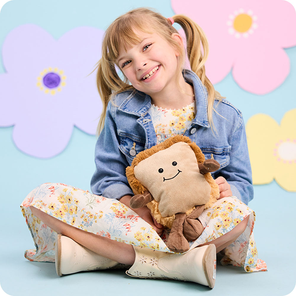 Image 96: girl holding bread stuffed animal warmies