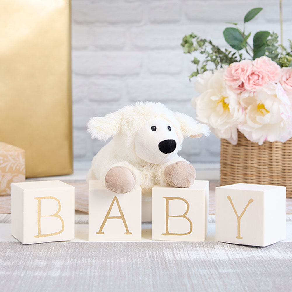 Image 99: laying down sheep stuffed animal on baby blocks