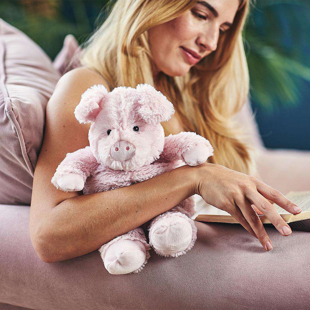 Image 101: Woman hugging Cute Weighted Lavender Scented Pig Stuffed Animal Heating Pad Warmies